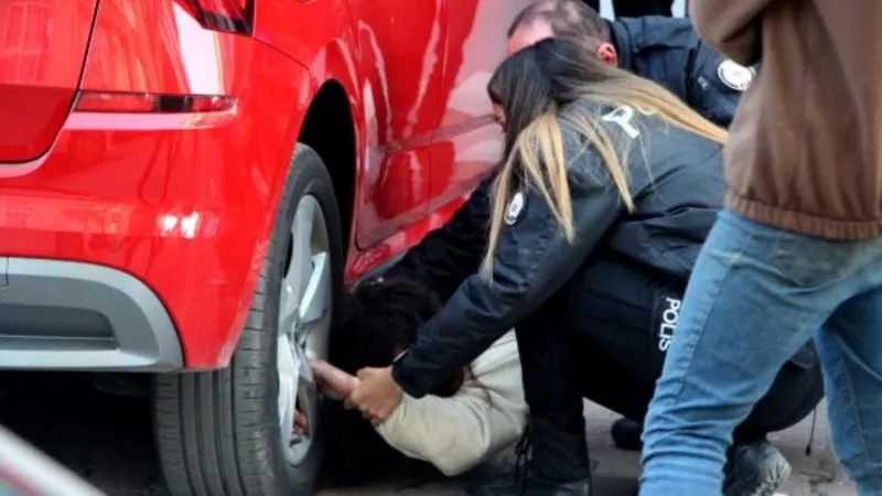 Uyuşturucu bağımlısı genç kız, otomobilin altına girip 2 saat polise direndi